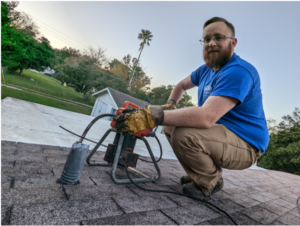 man with blue shirt on roof