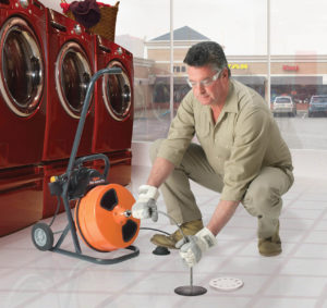 Plumber using Mini-Rooter Machine